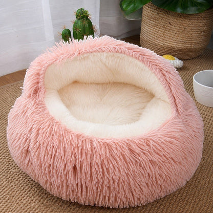 Cama antiestrés Purrfect Cozy Beds de felpa rosa y crema con forma de concha para gatos y perros pequeños