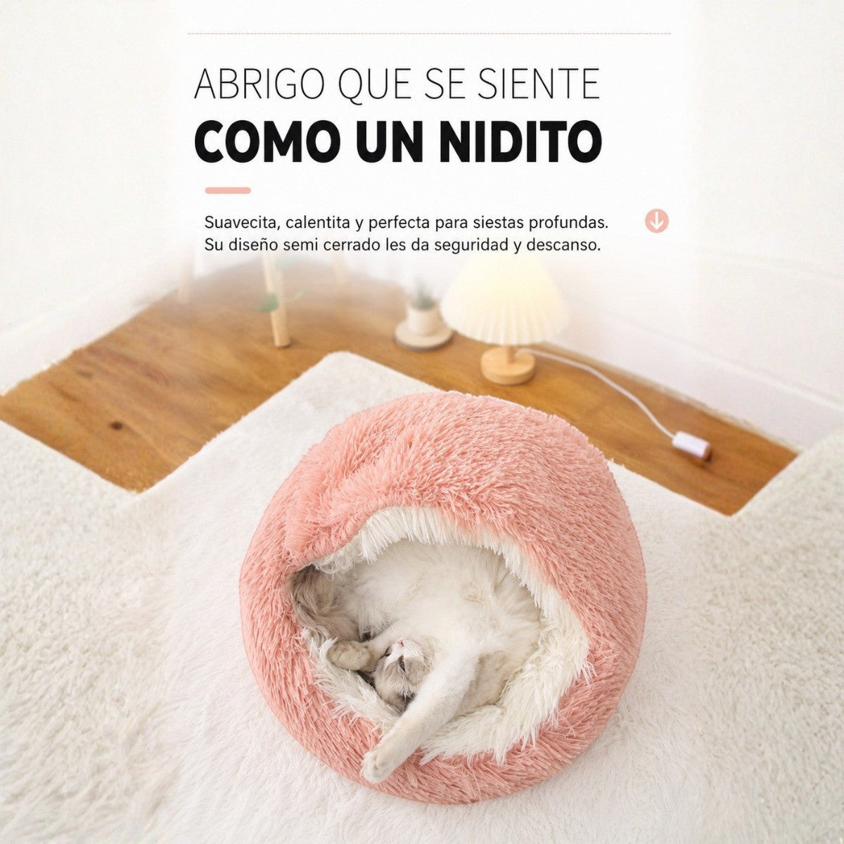 Cama antiestrés Purrfect Cozy Beds de felpa rosa tipo concha con un gato durmiendo cómodamente en su interior